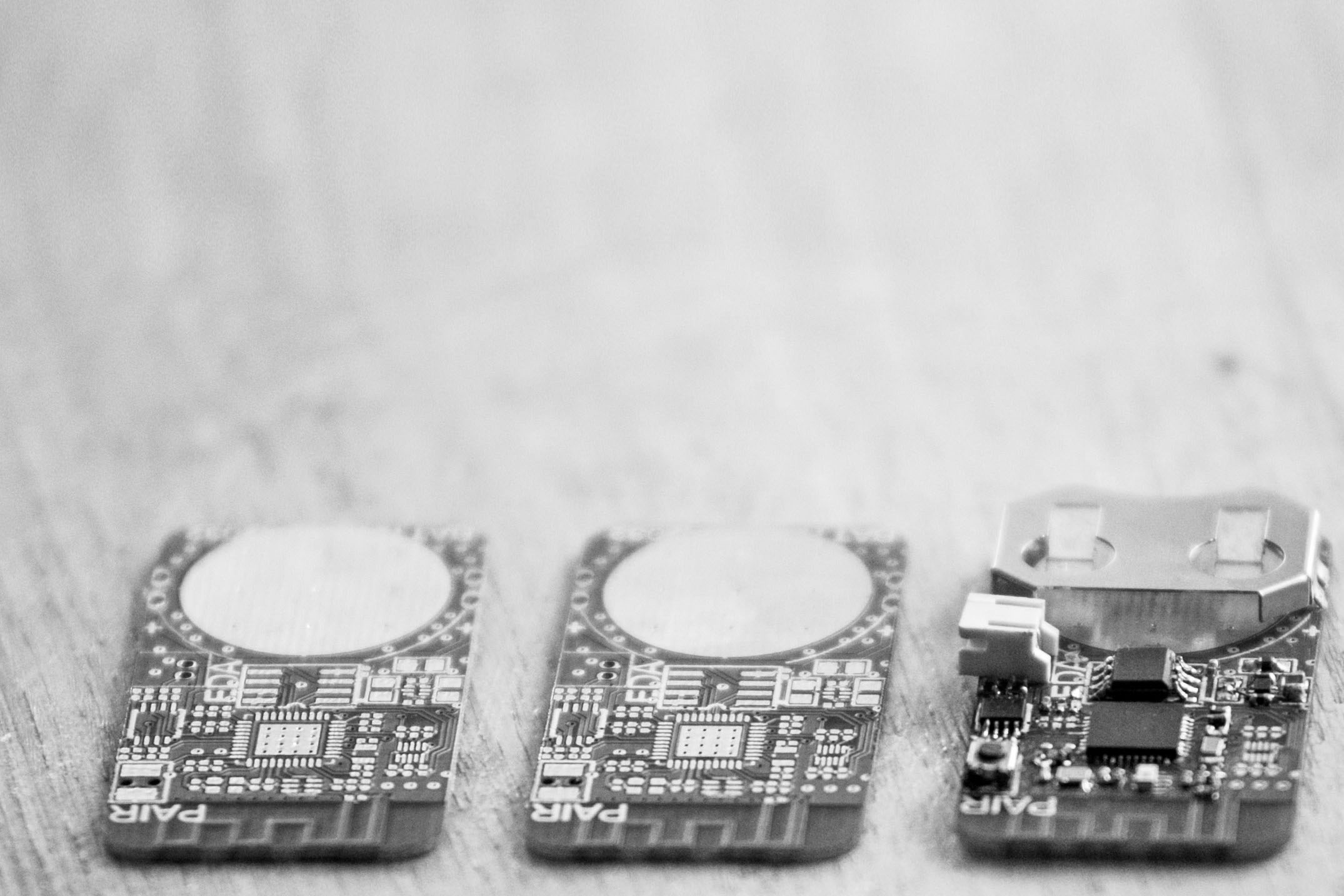 assembly of a pcb: on the left there are two pcbs without components and on the right there's the same pcb with all the components on.